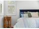 Serene bedroom with a navy headboard and striped bedding at 108 Corte Del Rosa, Venice, FL 34285