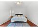 Bedroom with wood floors, ceiling fan and window shutters at 108 Corte Del Rosa, Venice, FL 34285