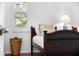 Cozy bedroom with twin beds, hardwood floors, and window shutters at 108 Corte Del Rosa, Venice, FL 34285