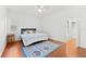 Main bedroom with king bed, hardwood floors, and access to the bathroom at 108 Corte Del Rosa, Venice, FL 34285