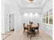 Round wooden dining table with four chairs in a bright dining room at 108 Corte Del Rosa, Venice, FL 34285