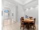 Formal dining area with round wooden table and chairs at 108 Corte Del Rosa, Venice, FL 34285