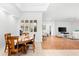 Dining room with view of living room and hardwood flooring at 108 Corte Del Rosa, Venice, FL 34285