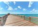 Long wooden pier extending over calm ocean waters at 108 Corte Del Rosa, Venice, FL 34285