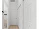Bright hallway with clean lines and access to storage at 108 Corte Del Rosa, Venice, FL 34285