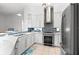 Modern kitchen with stainless steel appliances and white cabinetry at 108 Corte Del Rosa, Venice, FL 34285