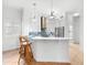 Modern kitchen with white cabinets and stainless steel appliances at 108 Corte Del Rosa, Venice, FL 34285