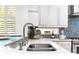 Modern double sink with a sleek chrome faucet at 108 Corte Del Rosa, Venice, FL 34285