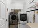 Convenient laundry room with washer, dryer, and ample shelving at 108 Corte Del Rosa, Venice, FL 34285