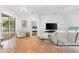 Spacious living room with tiled floors and access to patio at 108 Corte Del Rosa, Venice, FL 34285