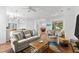 Bright living room with comfy sofas, a coffee table, and view to dining area at 108 Corte Del Rosa, Venice, FL 34285