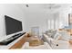 Bright living room with a large TV and comfortable sofa at 108 Corte Del Rosa, Venice, FL 34285