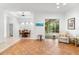 Bright living room features tile floors, dining area, and access to a relaxing patio at 108 Corte Del Rosa, Venice, FL 34285