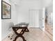 Home office with a large desk, built in shelving and hardwood floors at 108 Corte Del Rosa, Venice, FL 34285