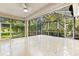 Spacious screened porch overlooking backyard with lush landscaping at 108 Corte Del Rosa, Venice, FL 34285
