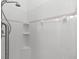 Clean shower with tiled walls and built-in shelves at 108 Corte Del Rosa, Venice, FL 34285