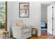 Relaxing sitting area featuring a comfy chair and natural light at 108 Corte Del Rosa, Venice, FL 34285