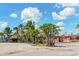 Beachfront businesses and palm trees line the street at 108 Corte Del Rosa, Venice, FL 34285