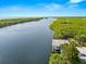 Boat lift and calm canal with lush greenery at 108 Corte Del Rosa, Venice, FL 34285
