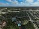 High-altitude aerial view showing the community pool, tennis court, and surrounding area at 109 Woodland Pl, Osprey, FL 34229