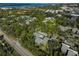 Aerial view of a condo community surrounded by trees and near amenities at 109 Woodland Pl, Osprey, FL 34229