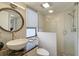Modern bathroom with white tile, glass shower, and vessel sink at 109 Woodland Pl, Osprey, FL 34229