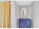 Small bathroom with blue cabinet, patterned shower curtain, and decorative mirror at 109 Woodland Pl, Osprey, FL 34229