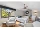 Well-lit bedroom with two beds, ample seating, and scenic views at 109 Woodland Pl, Osprey, FL 34229