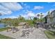 Outdoor community area with fire pit, picnic tables, and waterfront views at 109 Woodland Pl, Osprey, FL 34229