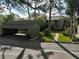 Community entrance with garages, landscaping, and walkway at 109 Woodland Pl, Osprey, FL 34229