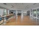 Large community room with wood floors, seating, and plenty of natural light at 109 Woodland Pl, Osprey, FL 34229
