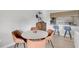 Dining area with a round table and four chairs adjacent to the kitchen at 109 Woodland Pl, Osprey, FL 34229