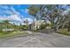 Community area with a waterfront view, mature trees, and ample parking at 109 Woodland Pl, Osprey, FL 34229