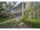 Backyard view of a two-story home with screened balconies at 109 Woodland Pl, Osprey, FL 34229
