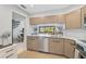Contemporary kitchen with lots of storage, stainless steel appliances and a breakfast bar at 109 Woodland Pl, Osprey, FL 34229