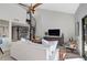 Living area with vaulted ceiling, white couch, and a view of the balcony at 109 Woodland Pl, Osprey, FL 34229