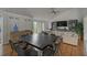 Spacious living room with vaulted ceilings, built-in bookshelves, and wood floors at 109 Woodland Pl, Osprey, FL 34229