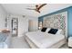 Main bedroom with ensuite laundry, plush bedding, and a private balcony at 109 Woodland Pl, Osprey, FL 34229
