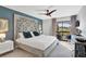 Stylish main bedroom with decorative headboard, ceiling fan, and balcony access at 109 Woodland Pl, Osprey, FL 34229
