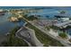 Aerial view of a coastal marina with boats, docks, and a nearby road at 109 Woodland Pl, Osprey, FL 34229