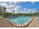 Community pool with lounge chairs and lush tropical foliage at 109 Woodland Pl, Osprey, FL 34229