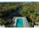 Community pool with plenty of lounge chairs and waterfront access at 109 Woodland Pl, Osprey, FL 34229