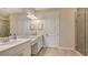 Elegant bathroom with dual vanities, a large mirror, and a glass-enclosed shower at 12667 Sorrento Way, Bradenton, FL 34211