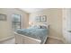 Charming bedroom with a white bed, large window, and soft carpeting at 12667 Sorrento Way, Bradenton, FL 34211