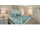 Cozy bedroom with a white bed, matching nightstands, and access to a bathroom at 12667 Sorrento Way, Bradenton, FL 34211