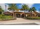 Exterior of the community clubhouse surrounded by palm trees at 12667 Sorrento Way, Bradenton, FL 34211