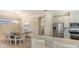 Kitchen and dining area with stainless steel appliances and white cabinetry at 12667 Sorrento Way, Bradenton, FL 34211
