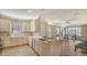 Open kitchen with white cabinets, stainless steel appliances, and tile floor at 12667 Sorrento Way, Bradenton, FL 34211