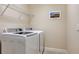 Laundry room with a front-loading washer and dryer at 12667 Sorrento Way, Bradenton, FL 34211