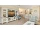Living room featuring a white entertainment center and tile flooring at 12667 Sorrento Way, Bradenton, FL 34211